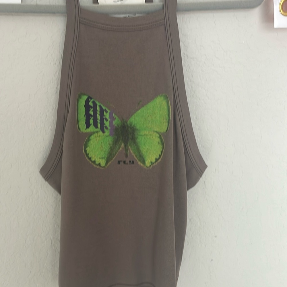 Light brown tank top with green butterfly